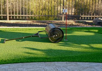 A sod roller on an artificial turf backyard putting green.